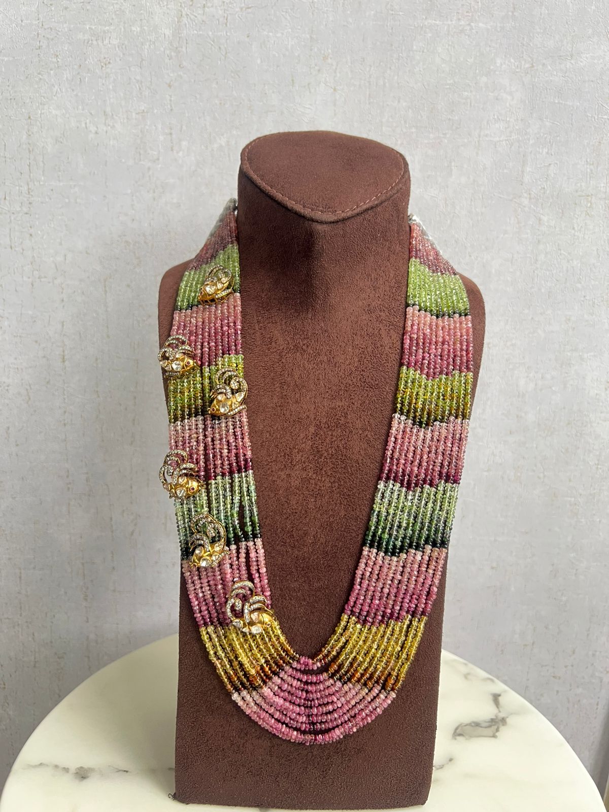 Multi colored tourmaline beads with side fish motif Multi colored tourmaline beads with side fish motif